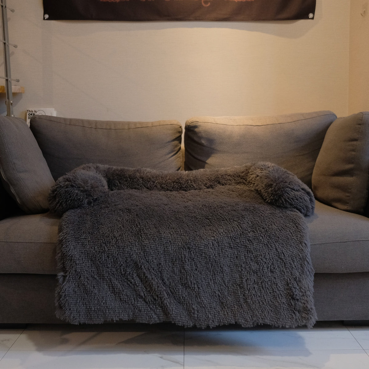 Charcoal grey calming bed on a sofa